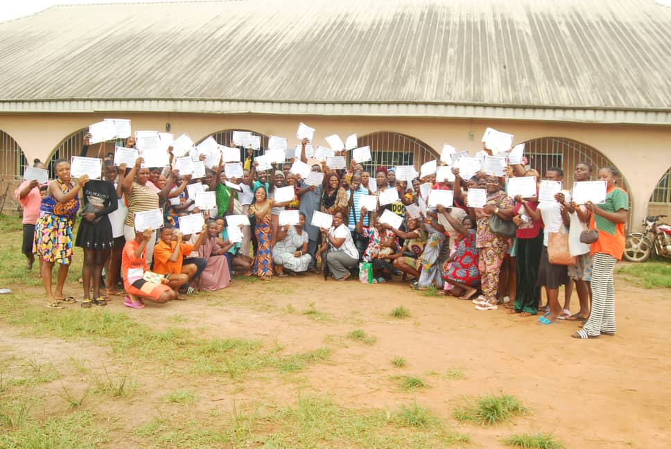 Women holding certificates at Empower Her Skills Training