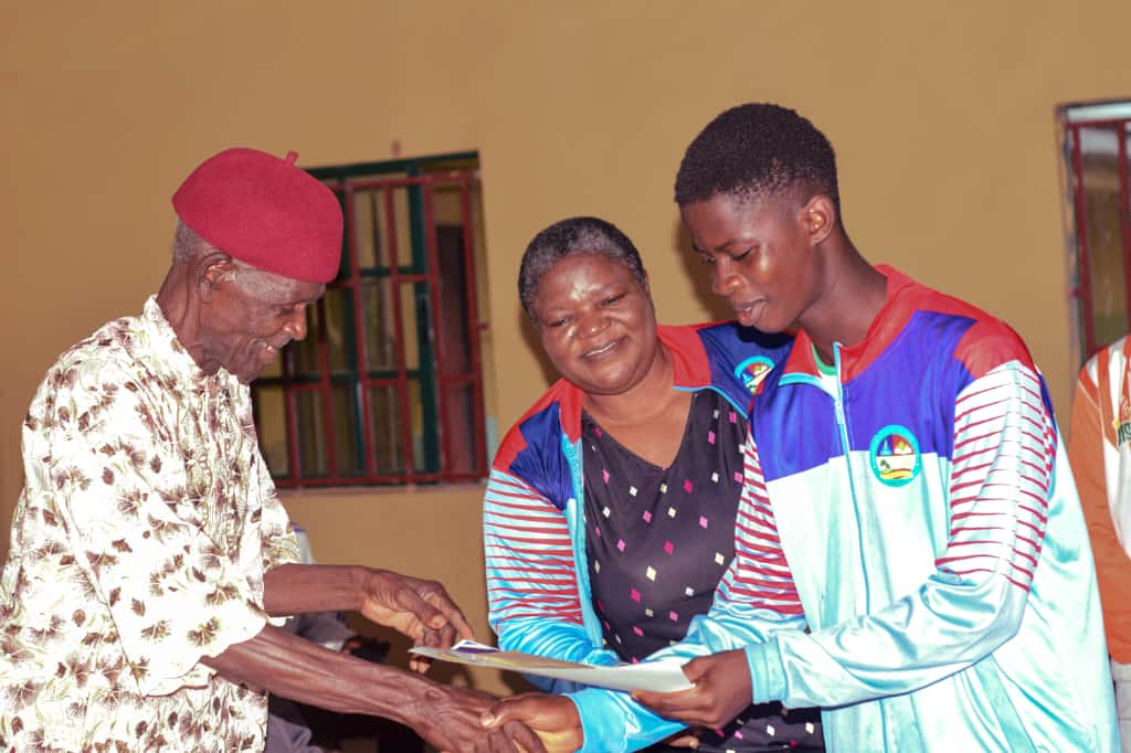 Elder honouring a young sports ambassador